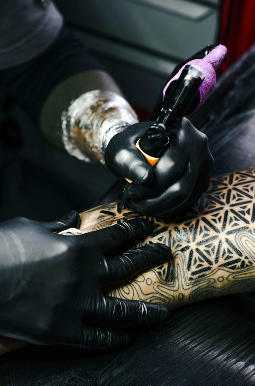 Tattoo Artist Tattooing Young Woman Stock Photo by ©microgen 178530732